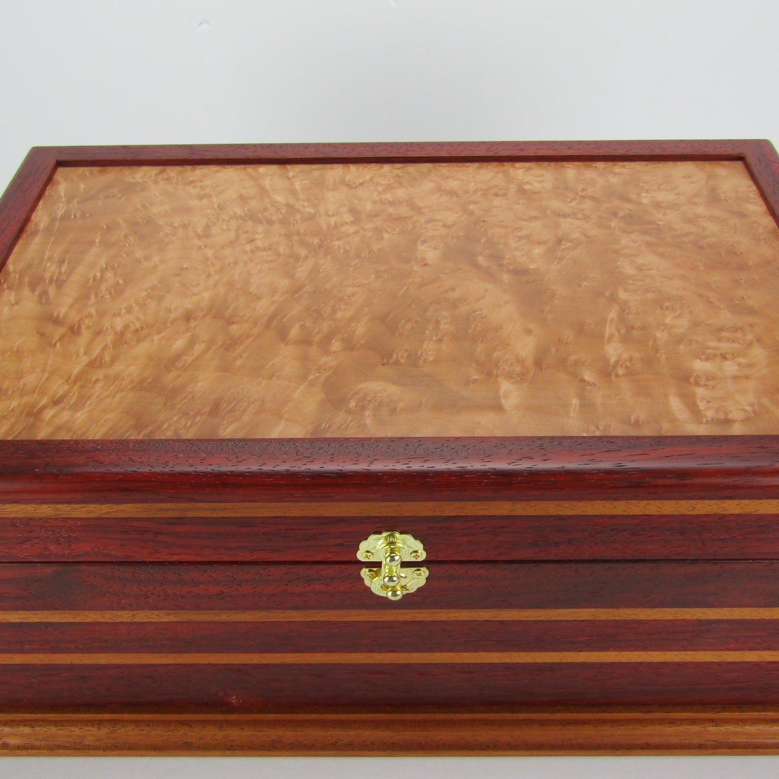 Top view of unique memorial keepsake box handmade from padauk, mahogany, and maple burl veneer  by A Finer Cut Woodworking. 