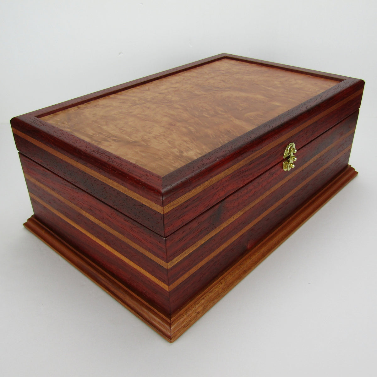 Front corner view of unique memorial keepsake box handmade from padauk, mahogany, and maple burl veneer  by A Finer Cut Woodworking.