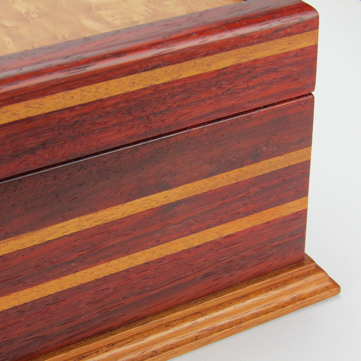 Inlays on unique memorial keepsake box handmade from padauk, mahogany, and maple burl veneer  by A Finer Cut Woodworking.