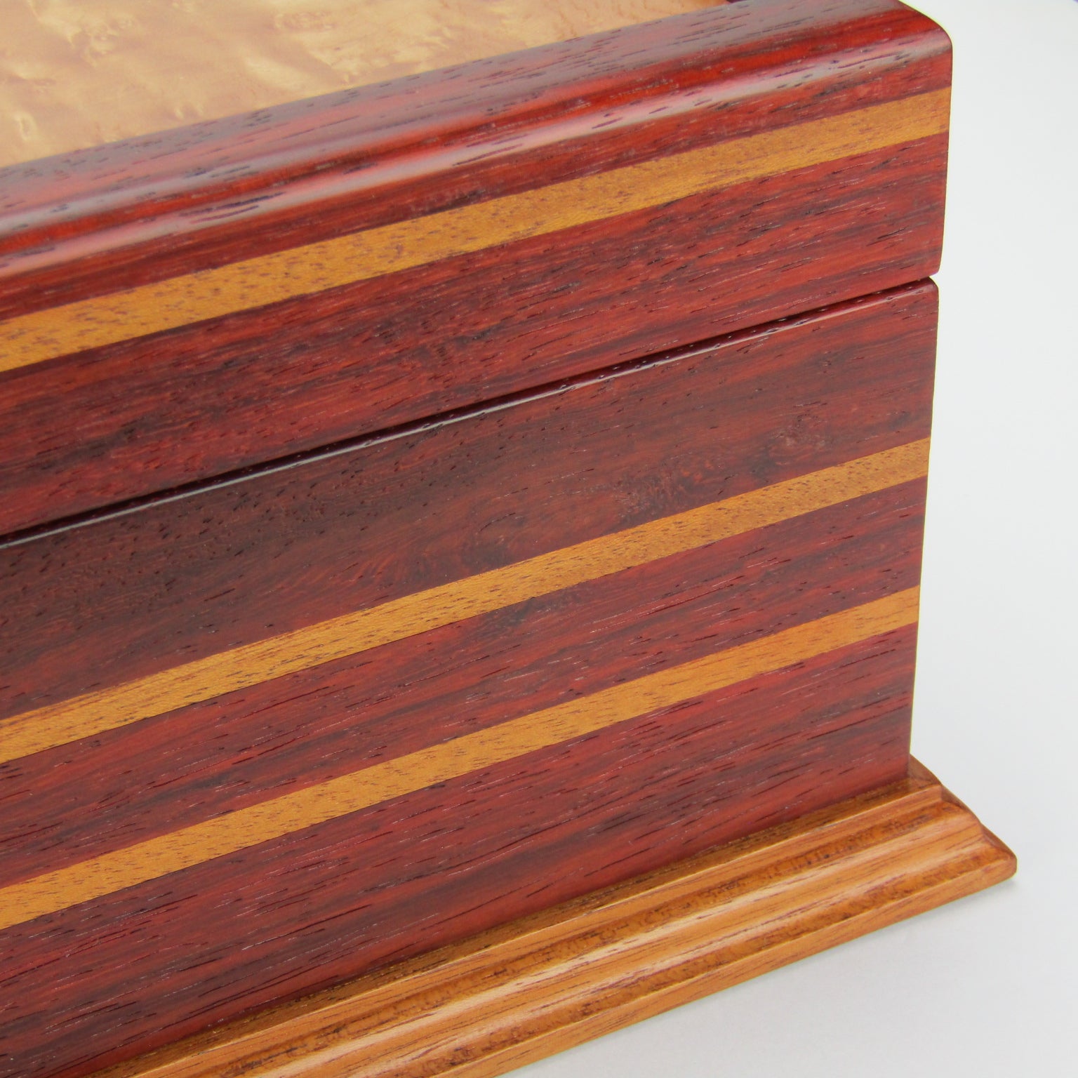 Inlays on unique memorial keepsake box handmade from padauk, mahogany, and maple burl veneer  by A Finer Cut Woodworking.
