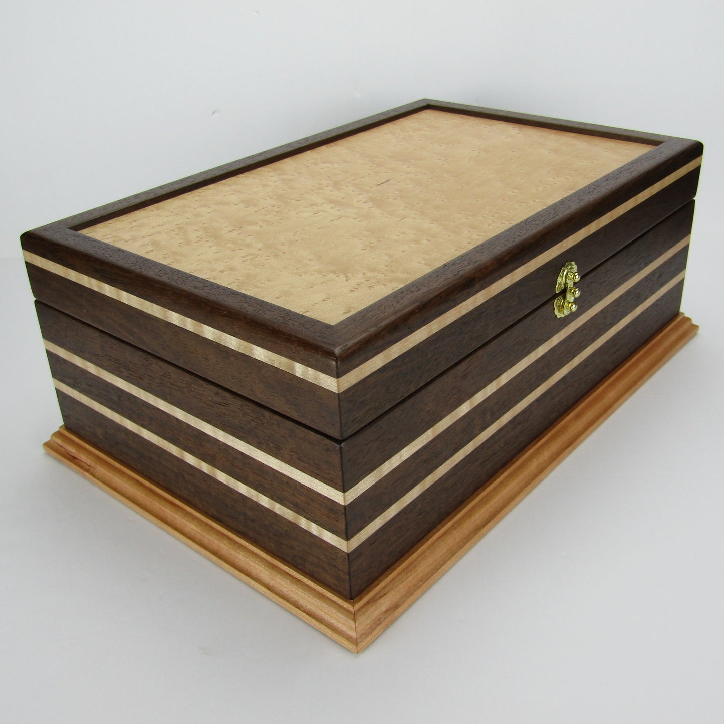 Front corner view of unique memorial keepsake box handmade from Peruvian walnut, curly maple, cherry, and bird's eye maple veneer  by A Finer Cut Woodworking.