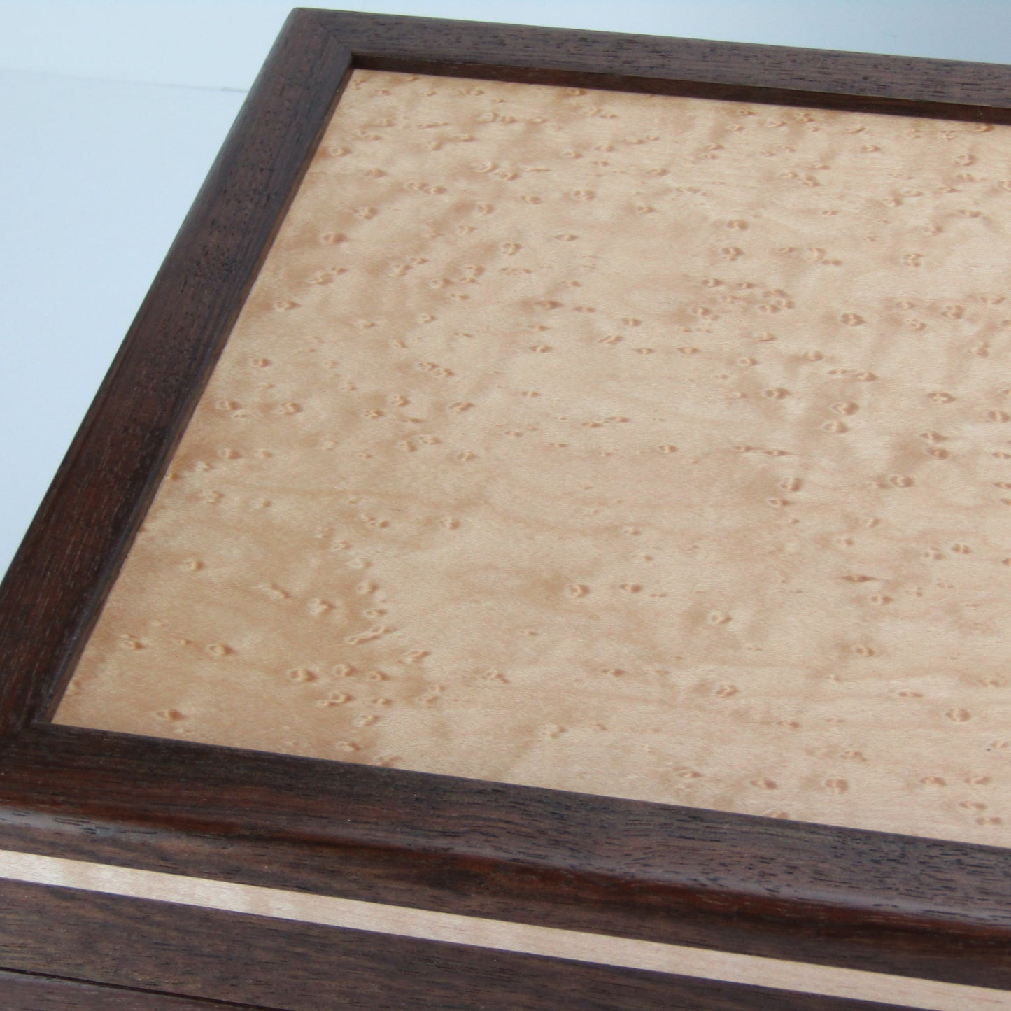 Lid details on unique memorial keepsake box handmade from Peruvian walnut, curly maple, cherry, and bird's eye maple veneer  by A Finer Cut Woodworking.