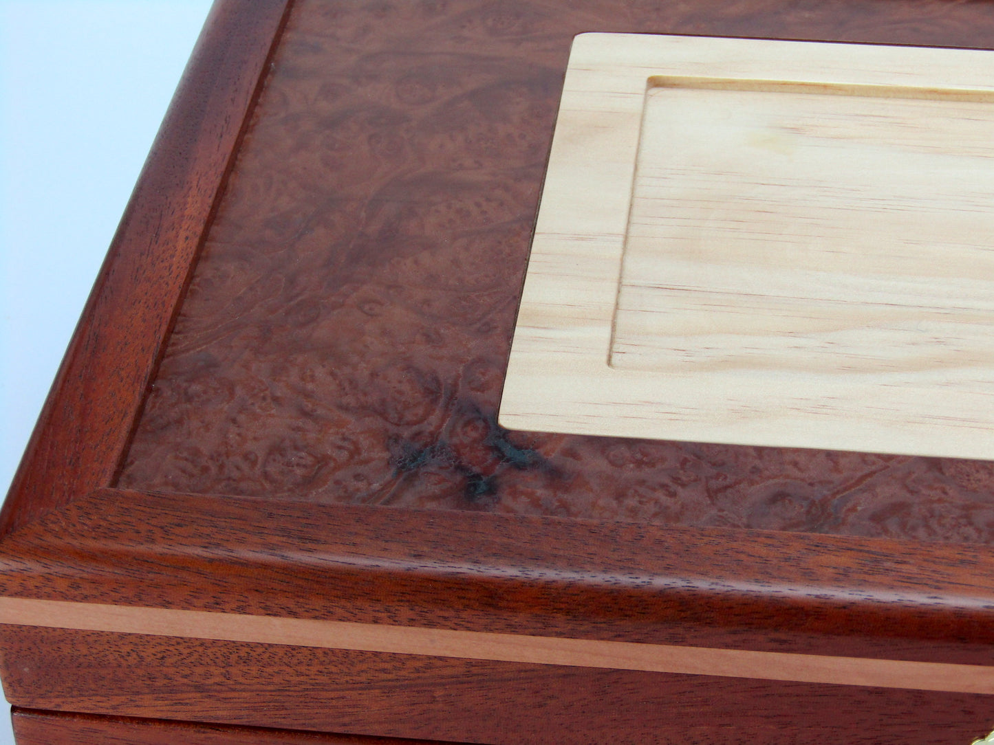 Lid details on pet memorial box handmade from Honduran mahogany and pear wood by A Finer Cut Woodwork.