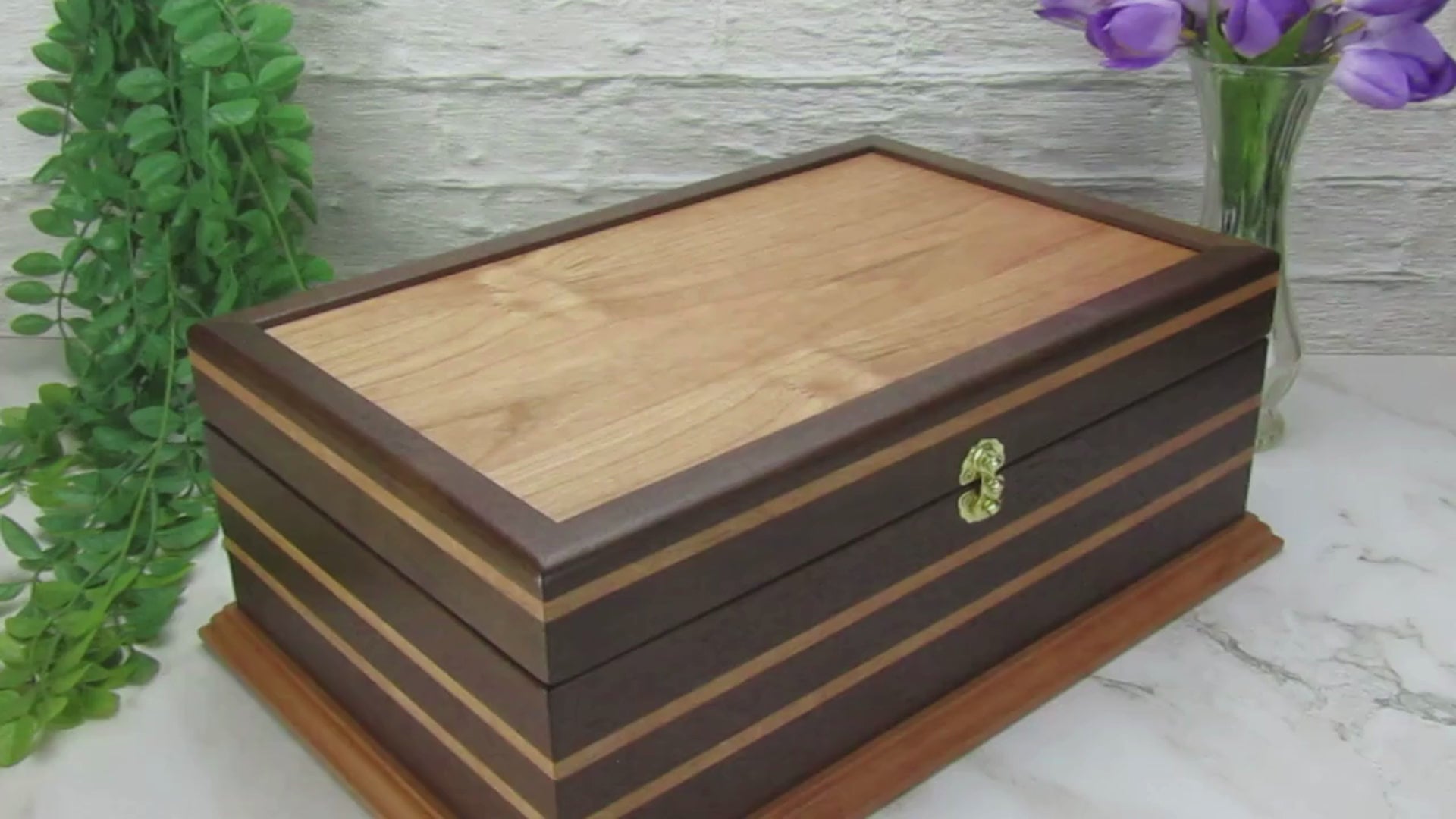 Video showing details of handmade keepsake box crafted from Peruvian walnut, cherry, cherry veneer, and a pear base by A Finer Cut Woodworking.
