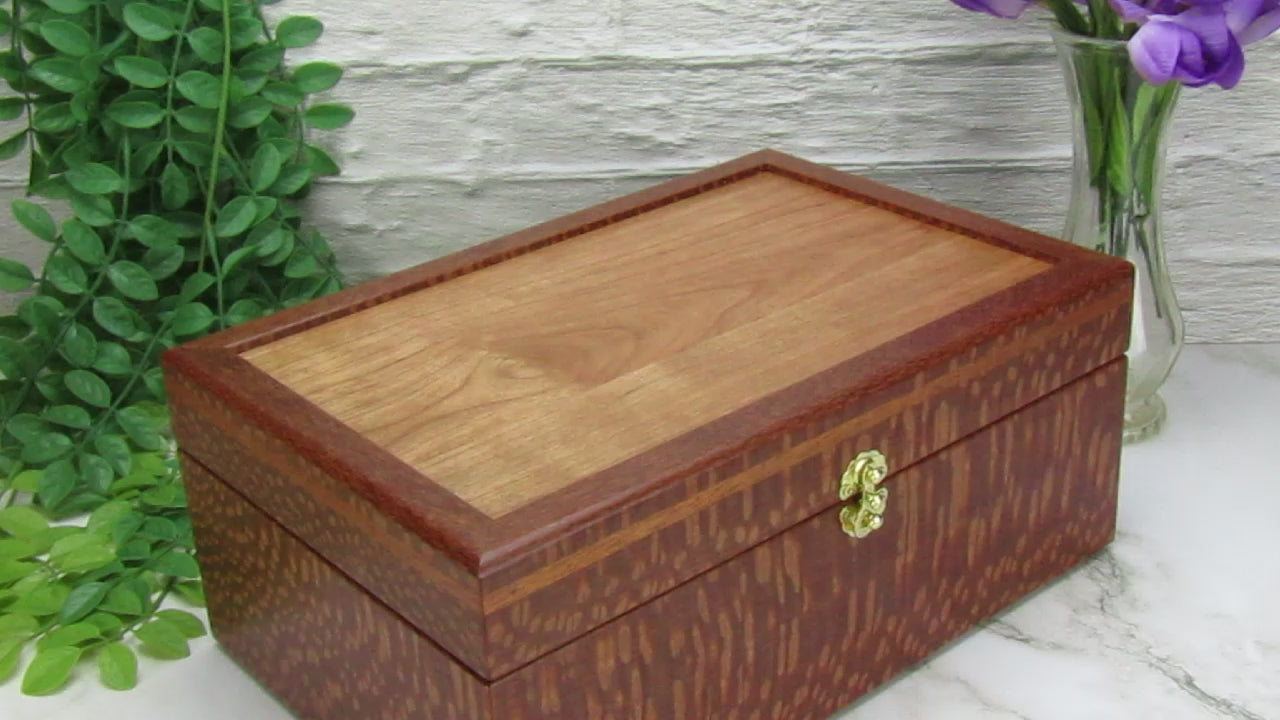 Video showing details of valet box for men handcrafted from leopardwood with mahogany inlay by A Finer Cut Woodworking.