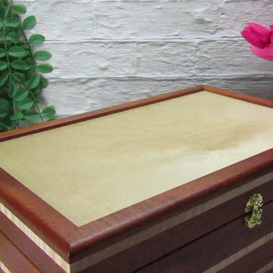 Video showing details of handmade wooden box crafted from mahogany, curly maple, and maple veneer by A Finer Cut Woodworking.