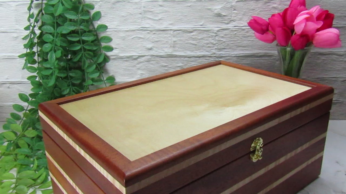 Video showing details of handmade wooden box crafted from mahogany, curly maple, and maple veneer by A Finer Cut Woodworking.