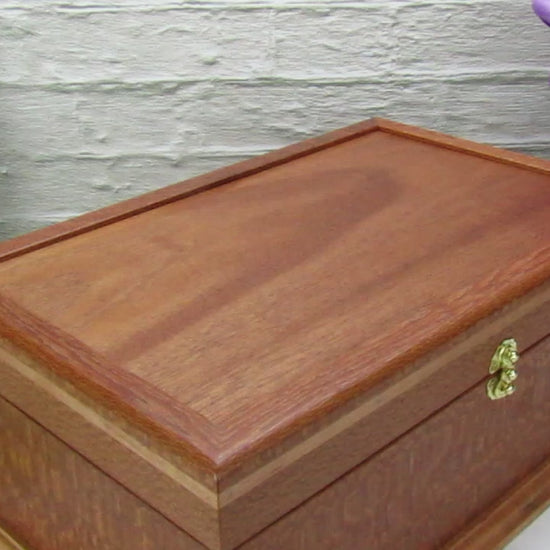 Video showing details of handmade keepsake box crafted from leopardwood, cherry, and mahogany veneer by A Finer Cut Woodworking.