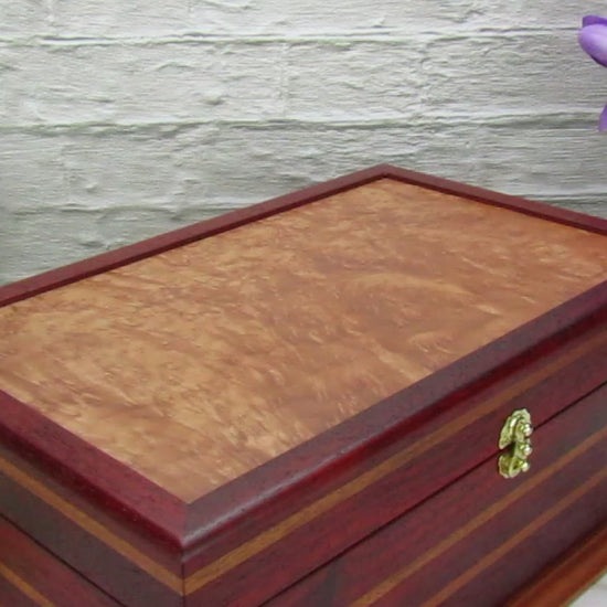 Video showing details of unique memorial keepsake box handmade from padauk, mahogany, and maple burl veneer  by A Finer Cut Woodworking.