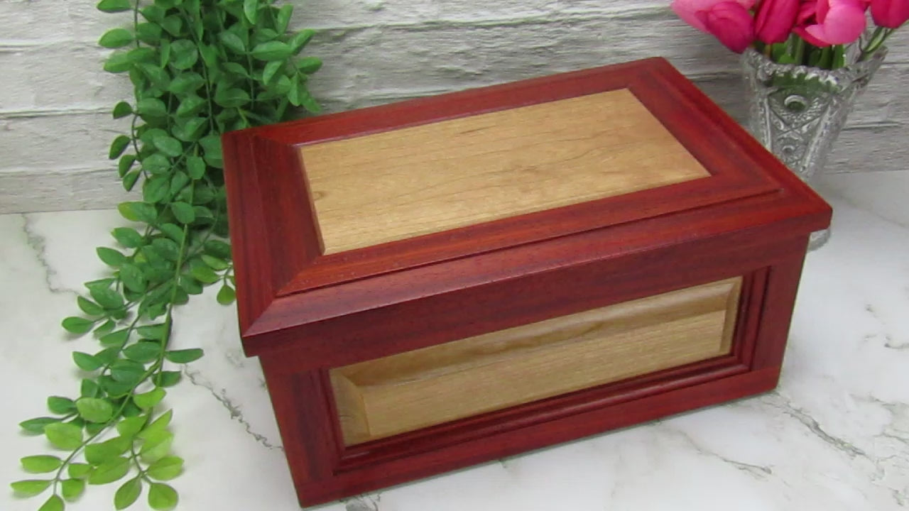 Video showing details of large keepsake box with raised panels handcrafted from padauk and cherry wood by A Finer Cut.