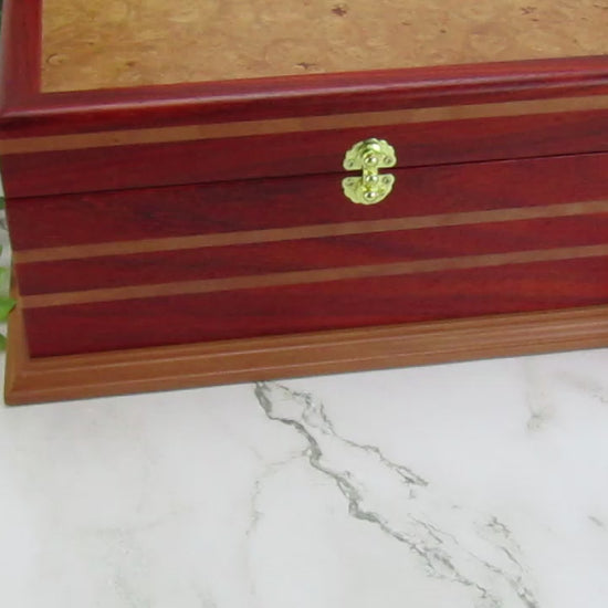 Video showing details of unique memorial box handcrafted from red padauk and pear wood by A Finer Cut Woodworking. 