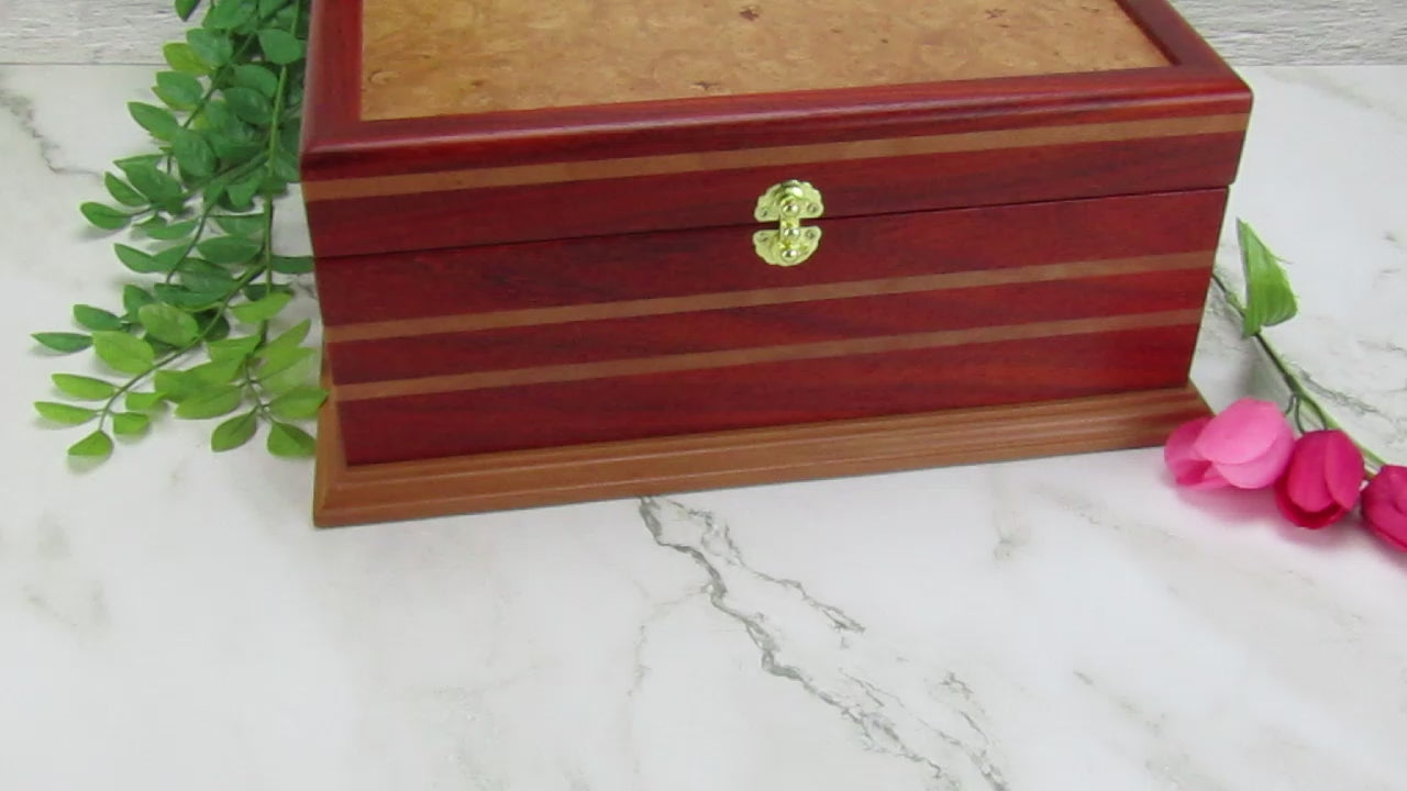 Video showing details of unique memorial box handcrafted from red padauk and pear wood by A Finer Cut Woodworking. 