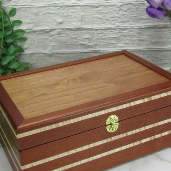 Video showing details of valet box for men handcrafted from mahogany, curly maple, and cherry veneer by A Finer Cut Woodworking.