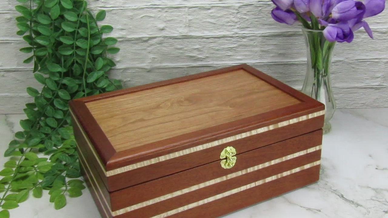 Video showing details of valet box for men handcrafted from mahogany, curly maple, and cherry veneer by A Finer Cut Woodworking.