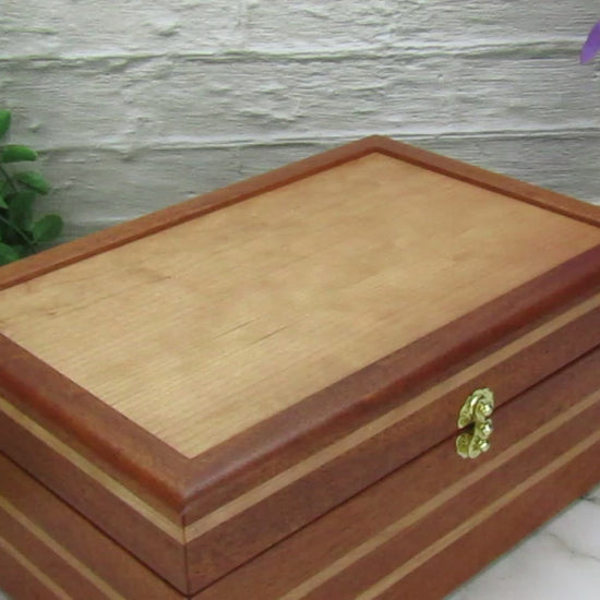 Video showing details of valet box for men handcrafted from mahogany, cherry, and cherry veneer by A Finer Cut Woodworking.