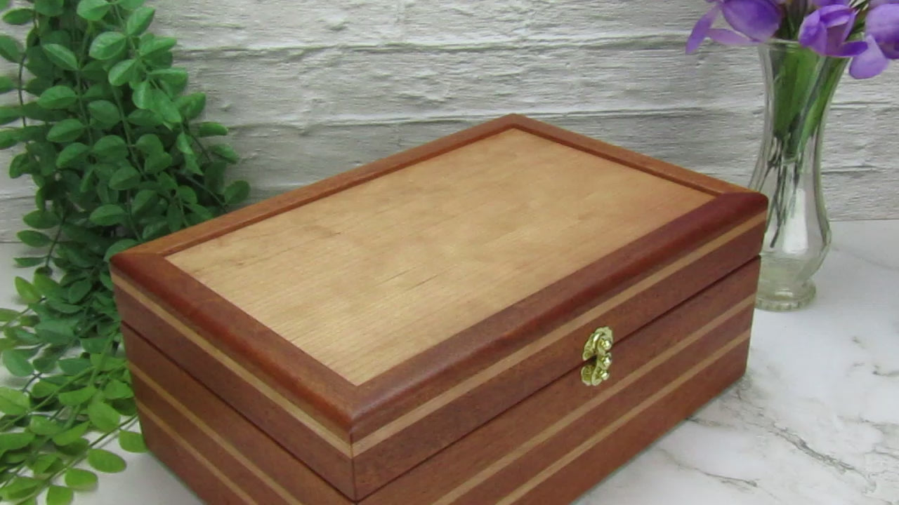 Video showing details of valet box for men handcrafted from mahogany, cherry, and cherry veneer by A Finer Cut Woodworking.