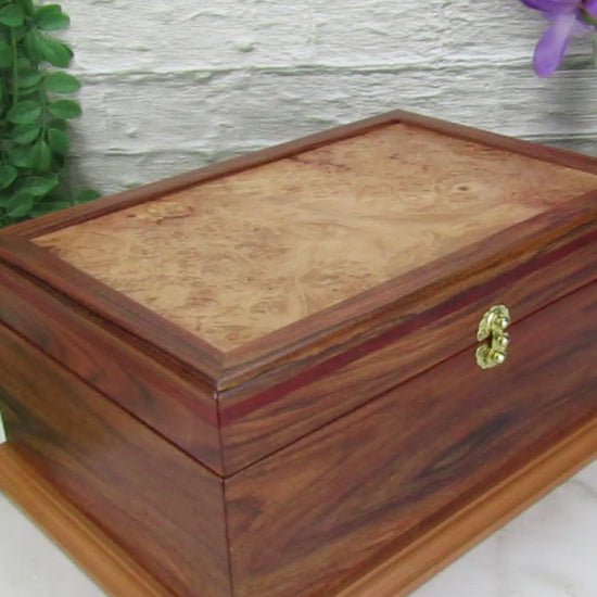 Video showing details of unique memorial keepsake box handmade from Bolivian rosewood and padauk by A Finer Cut Woodworking.