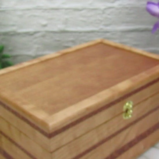 Video showing details of large keepsake box handmade from quilted cherry, leopardwood, and cherry veneer by A Finer Cut Woodworking.