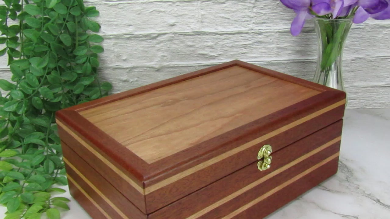 Video showing details of unique memorial box handcrafted from Honduran mahogany and cherry by A Finer Cut Woodworking. 