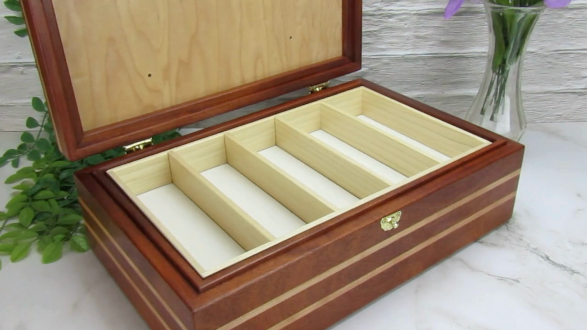 Video showing details of children's memory box with photo lid handmade from mahogany, cherry, and maple burl veneer by A Finer Cut Woodworking. 