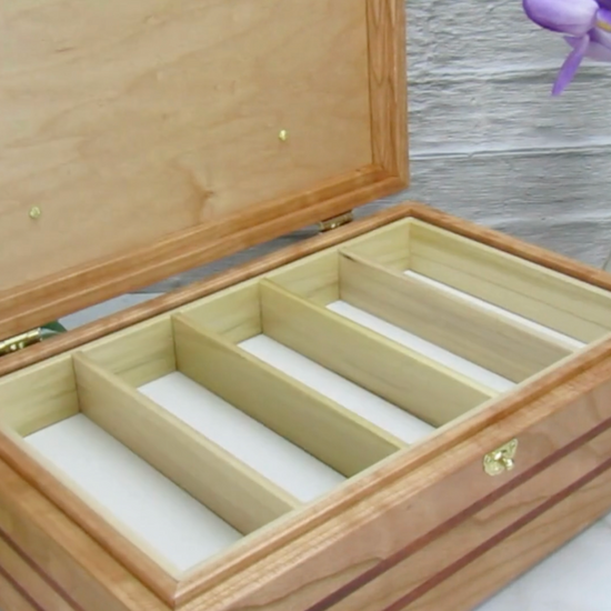 Video showing details of children's memory box with photo lid handmade from  cherry, mahogany, and dark finished cherry veneer by A Finer Cut Woodworking. 