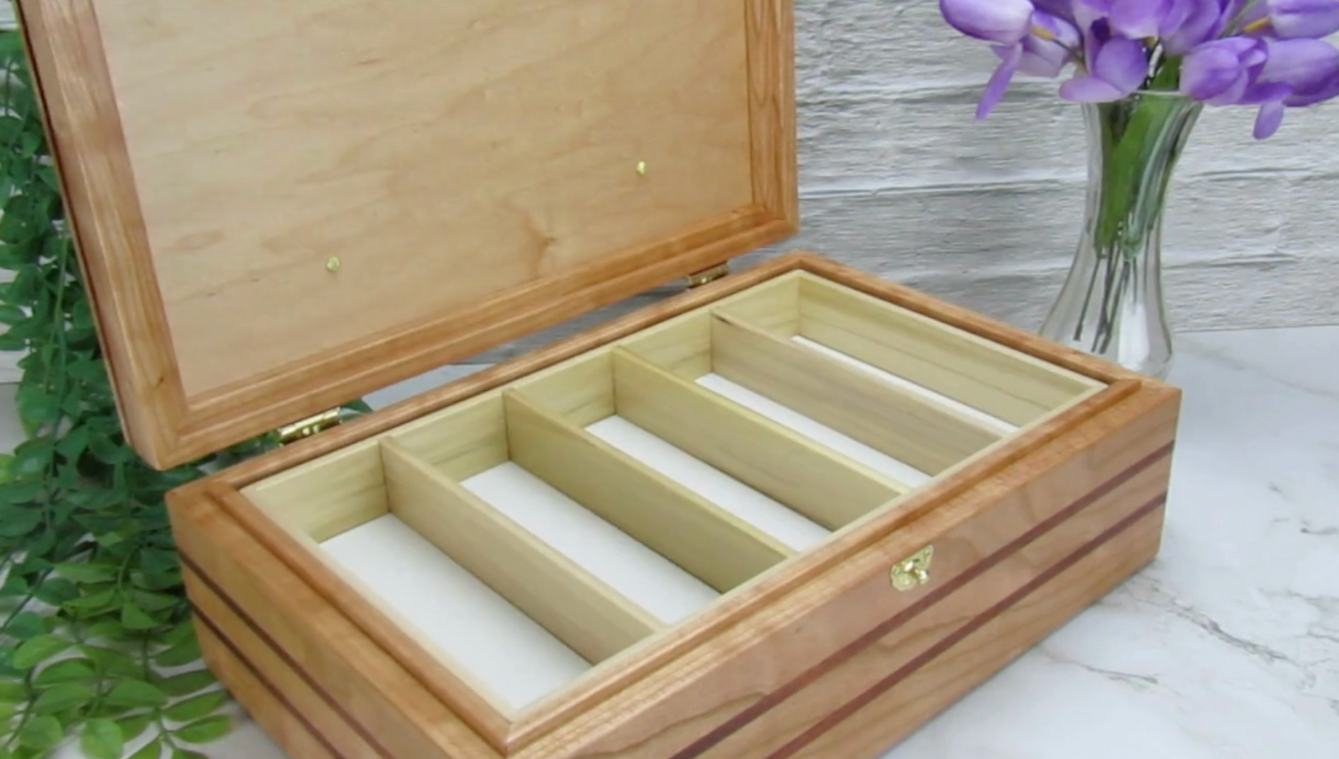 Video showing details of children's memory box with photo lid handmade from  cherry, mahogany, and dark finished cherry veneer by A Finer Cut Woodworking. 