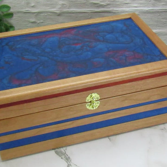 Video showing details of keepsake memory box handmade from cherry wood with padauk and epoxy inlays by A Finer Cut Woodwork.