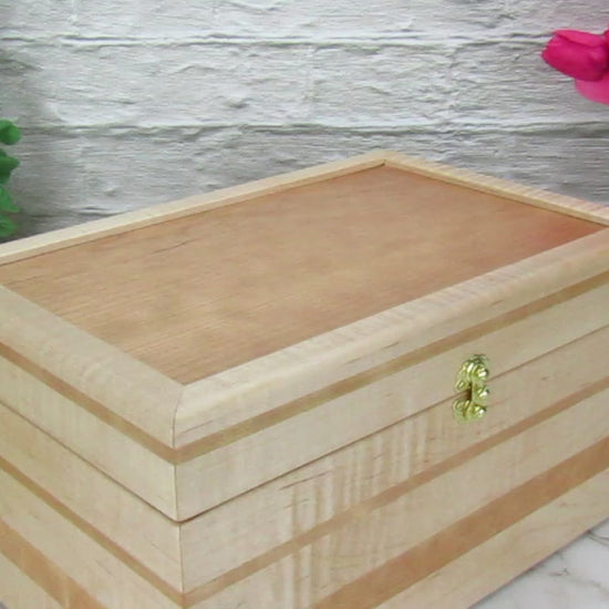 Video showing details of wooden memory box handmade from curly maple and cherry by A Finer Cut Woodworking.
