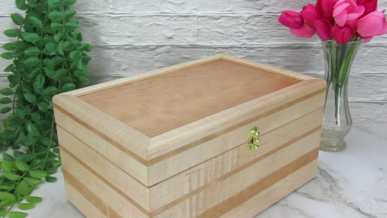 Video showing details of wooden memory box handmade from curly maple and cherry by A Finer Cut Woodworking.