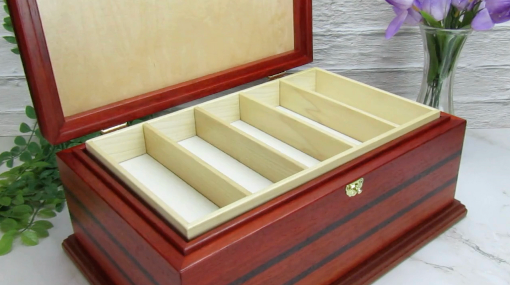 Video showing details of handmade wooden box crafted from padauk, wenge, Brazilian cherry, and walnut burl veneer by A Finer Cut Woodworking.