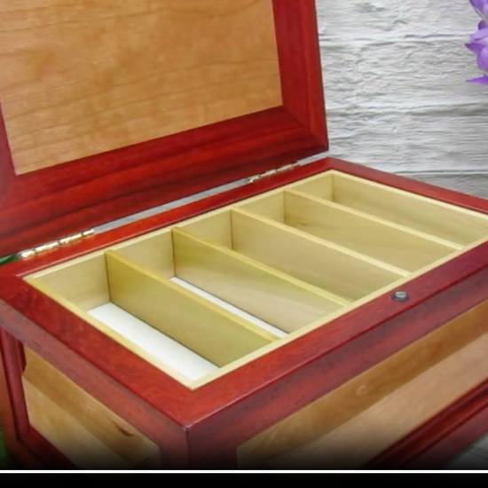 Video showing details of large keepsake box with raised panels handcrafted from padauk and cherry wood by A Finer Cut.