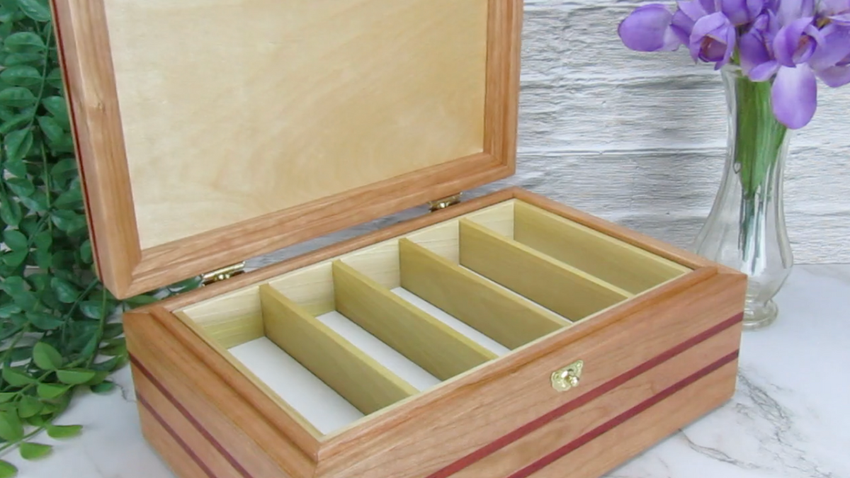 Video showing details of unique memorial box handcrafted from domestic cherry, padauk, and dark finished cherry veneer by A Finer Cut Woodworking. 