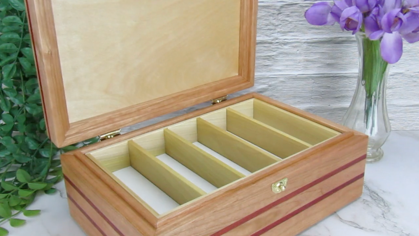 Video showing details of unique memorial box handcrafted from domestic cherry, padauk, and dark finished cherry veneer by A Finer Cut Woodworking. 