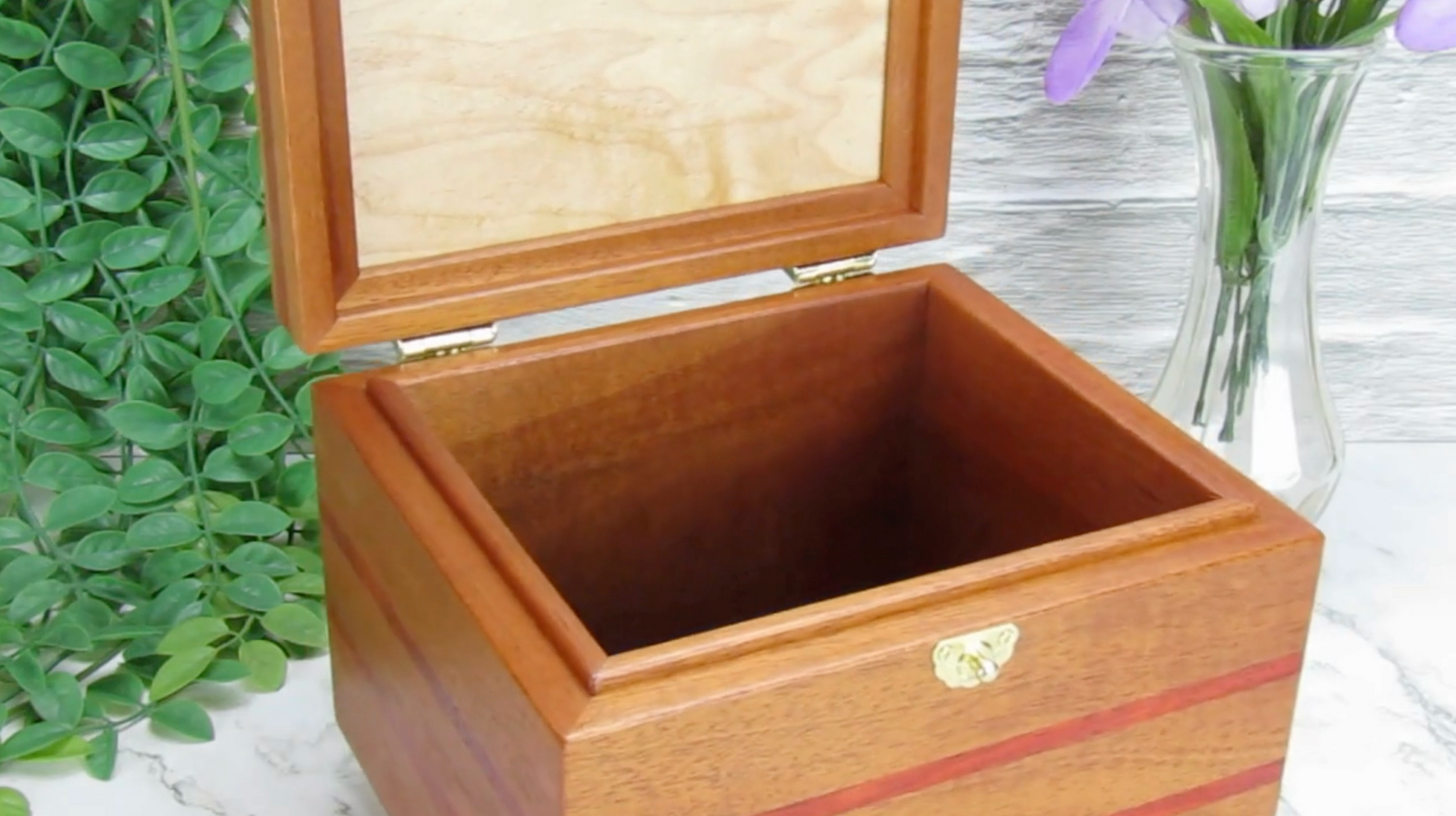 Video showing details of unique small keepsake box handmade from mahogany, padauk, and red finished cherry veneer by A Finer Cut Woodworking.