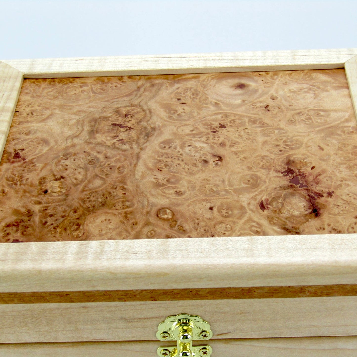 Lid details on unique small keepsake box handmade from curly maple and lacewood by A Finer Cut Woodworking. 