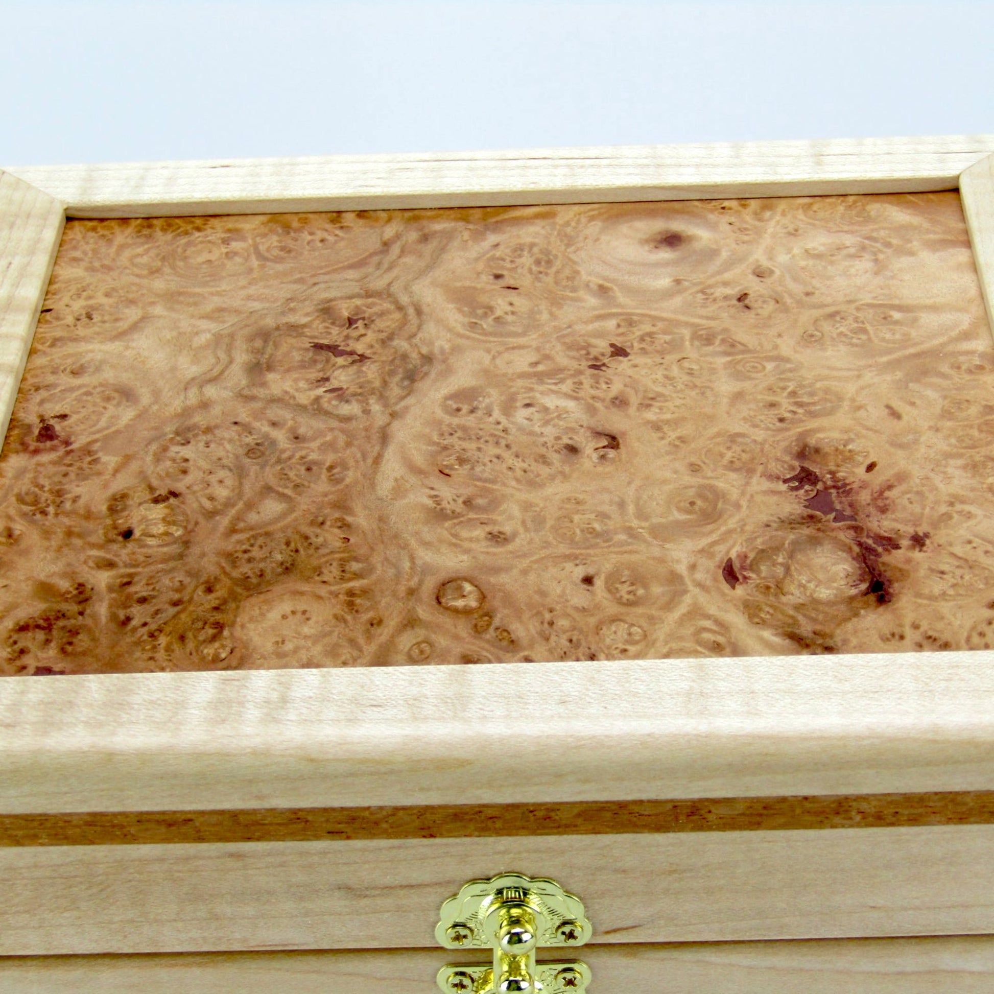 Lid details on unique small keepsake box handmade from curly maple and lacewood by A Finer Cut Woodworking. 