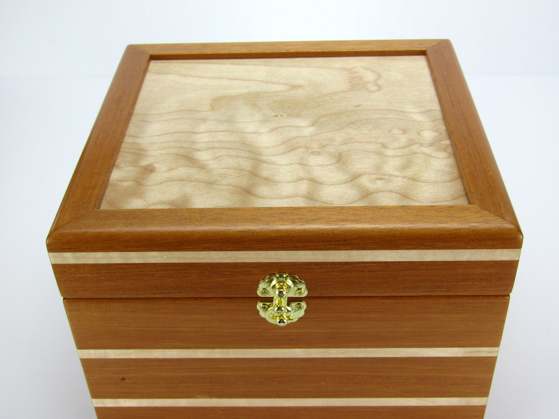 Lid details on unique small keepsake box handmade from mahogany and maple wood by A Finer Cut Woodworking. 