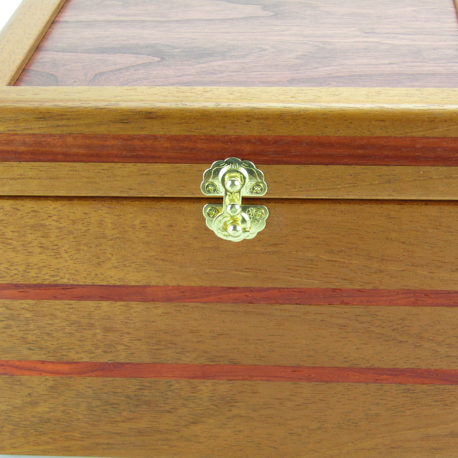 Inlays on unique small keepsake box handmade from mahogany, padauk, and red finished cherry veneer by A Finer Cut Woodworking.