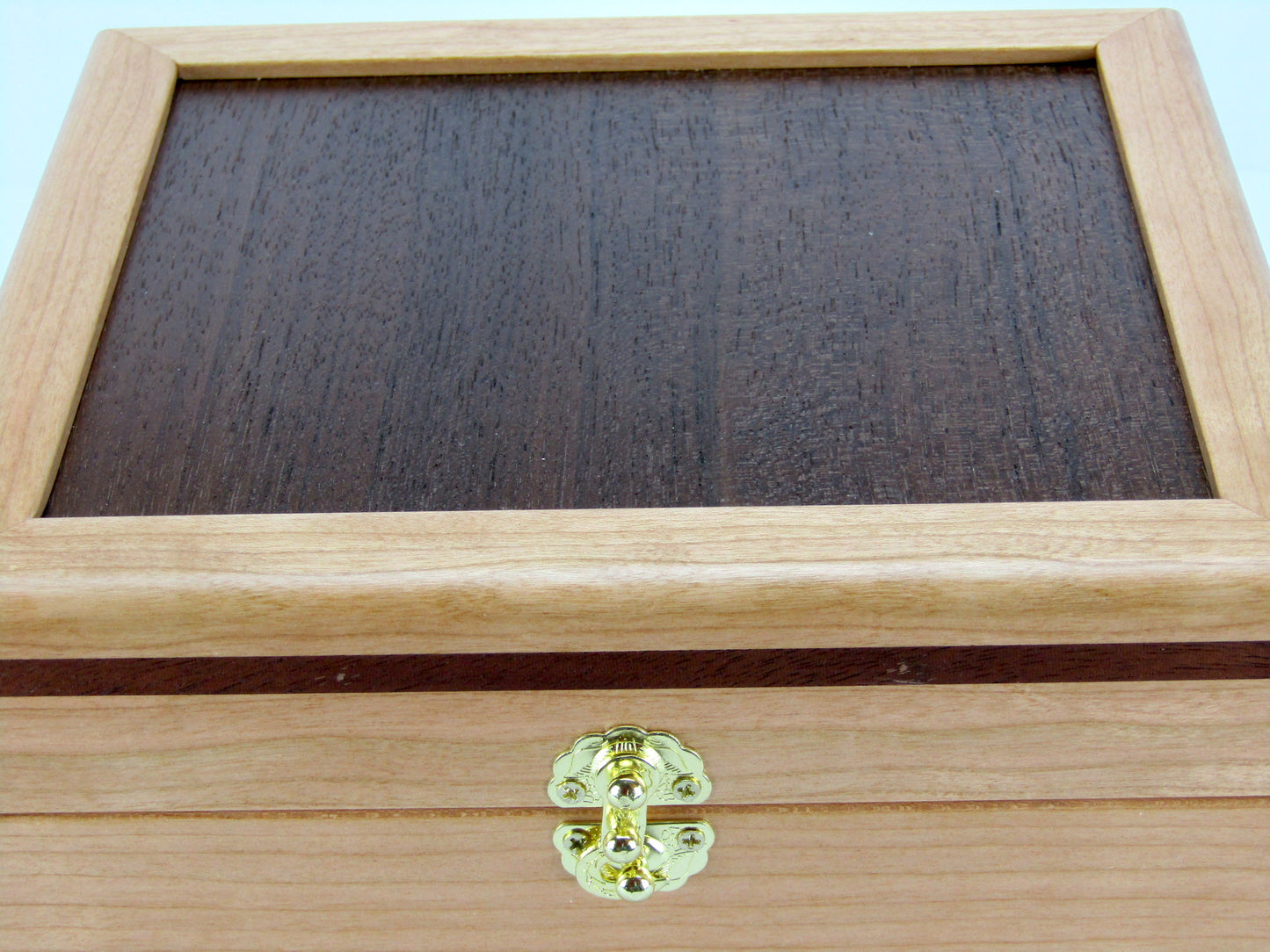 Lid details on unique small keepsake box handmade from cherry, mahogany and Peruvian walnut wood by A Finer Cut.