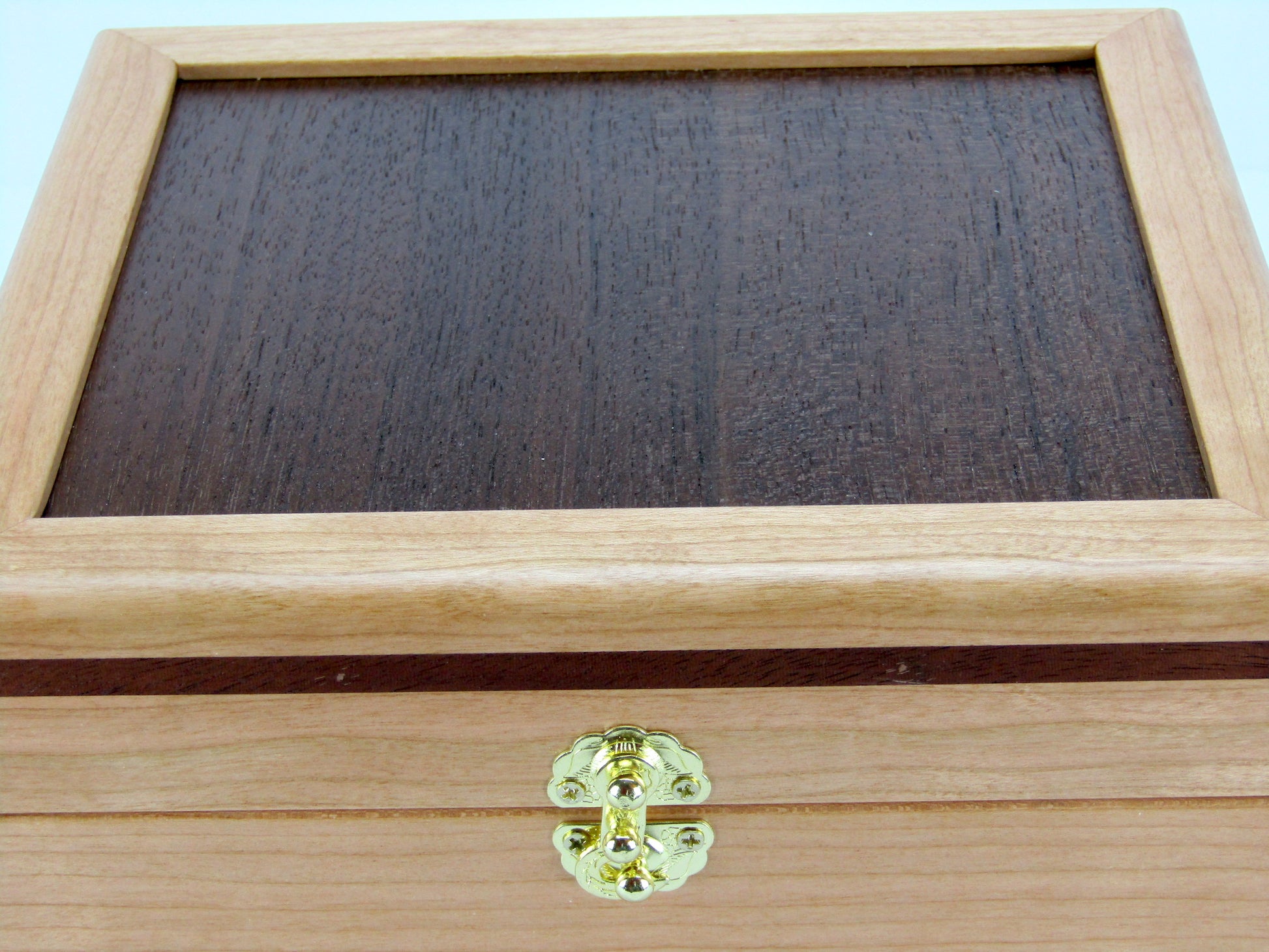 Lid details on unique small keepsake box handmade from cherry, mahogany and Peruvian walnut wood by A Finer Cut.