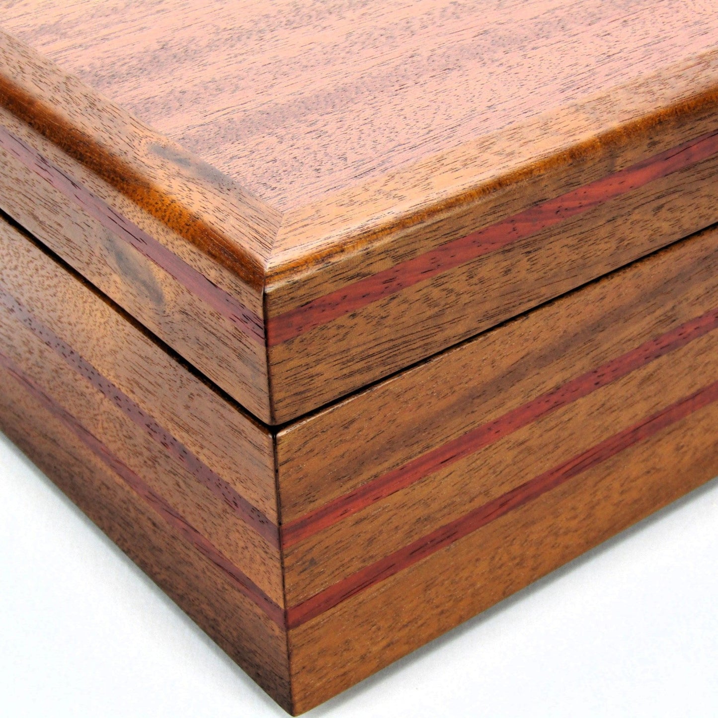 Inlays on valet box for men handcrafted from mahogany with padauk wood inlays by A Finer Cut Woodworking.