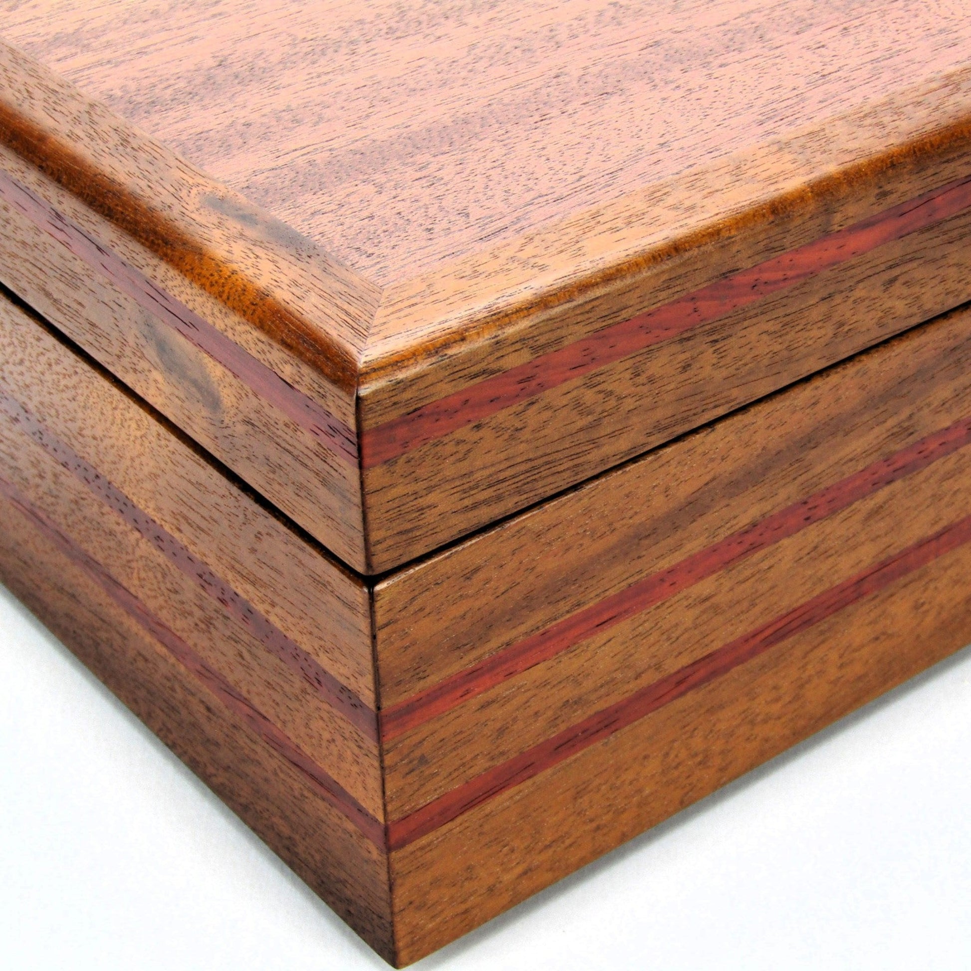 Inlays on valet box for men handcrafted from mahogany with padauk wood inlays by A Finer Cut Woodworking.