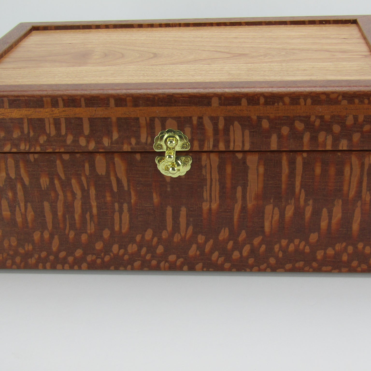 Front view of valet box for men handcrafted from leopardwood with mahogany inlay by A Finer Cut Woodworking.