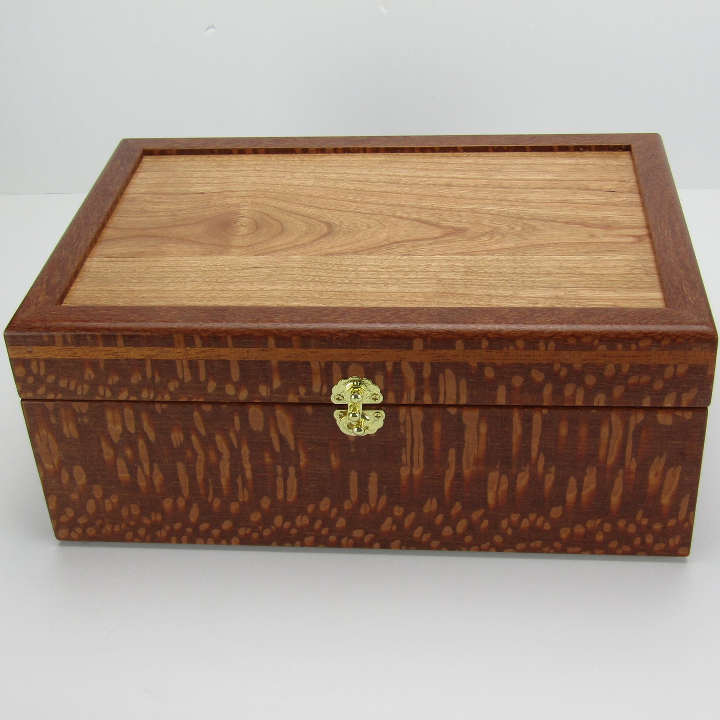 Top view of valet box for men handcrafted from leopardwood with mahogany inlay by A Finer Cut Woodworking.