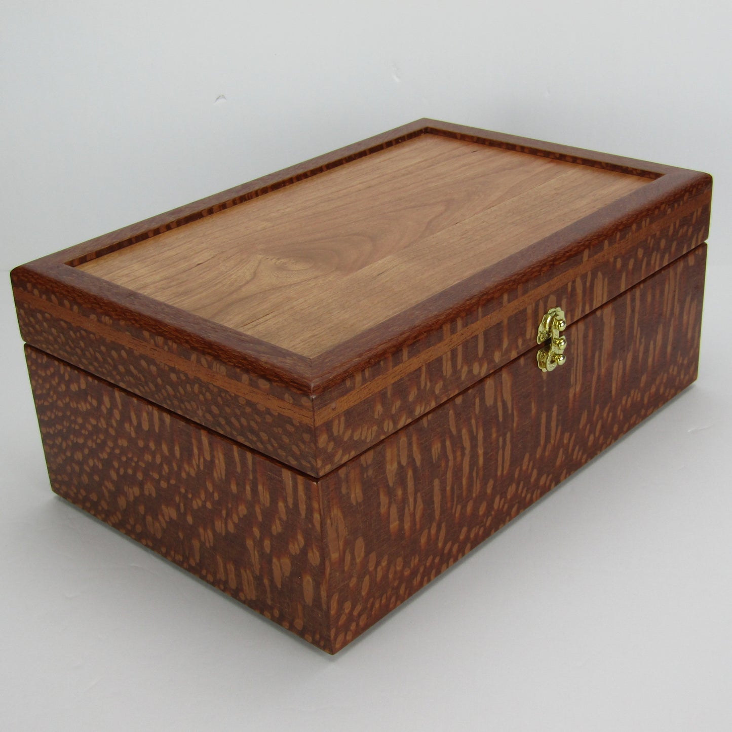 Front corner view of valet box for men handcrafted from leopardwood with mahogany inlay by A Finer Cut Woodworking.