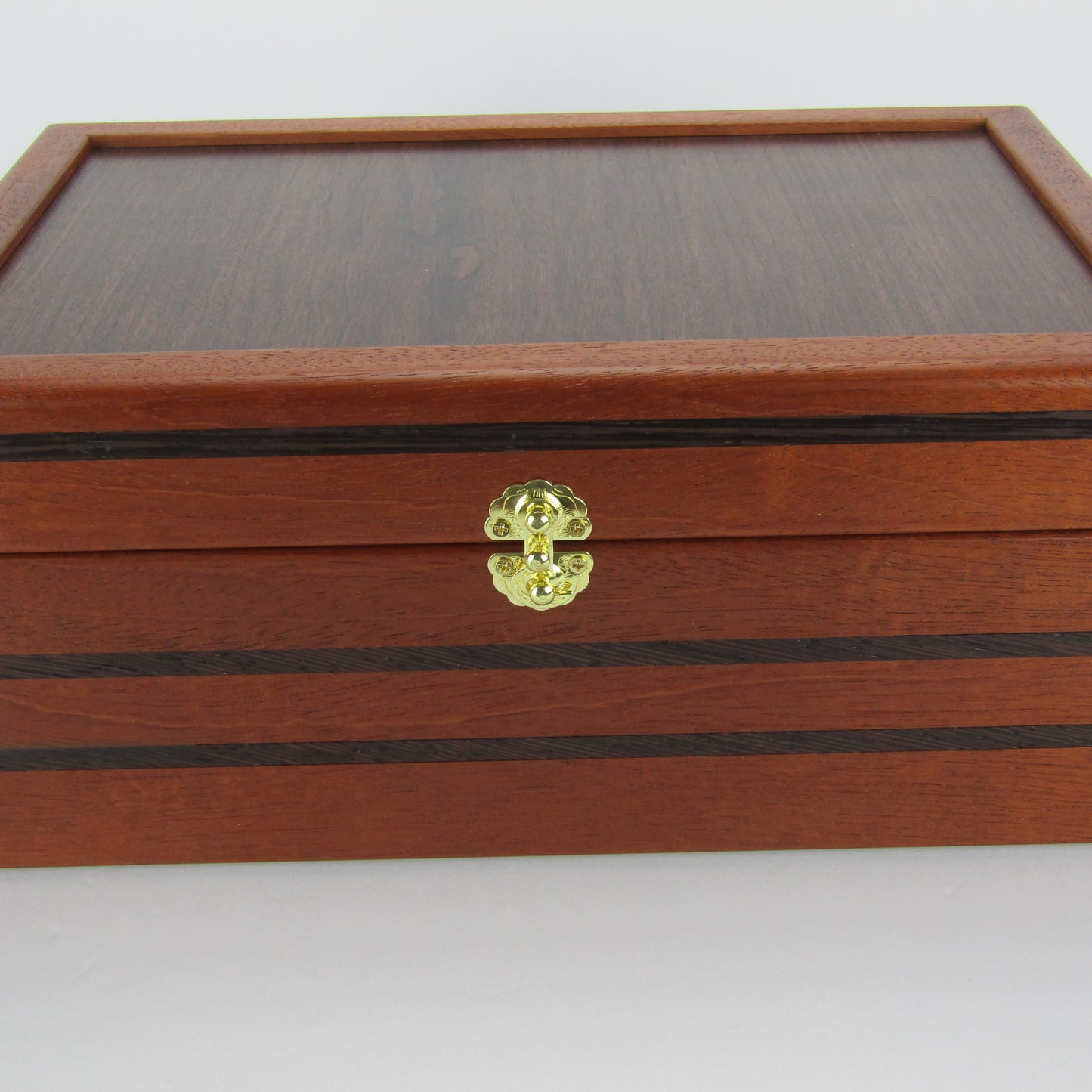 Front view of valet box for men handcrafted from mahogany, with wenge inlay and a dark finished cherry veneer lid  by A Finer Cut Woodworking.