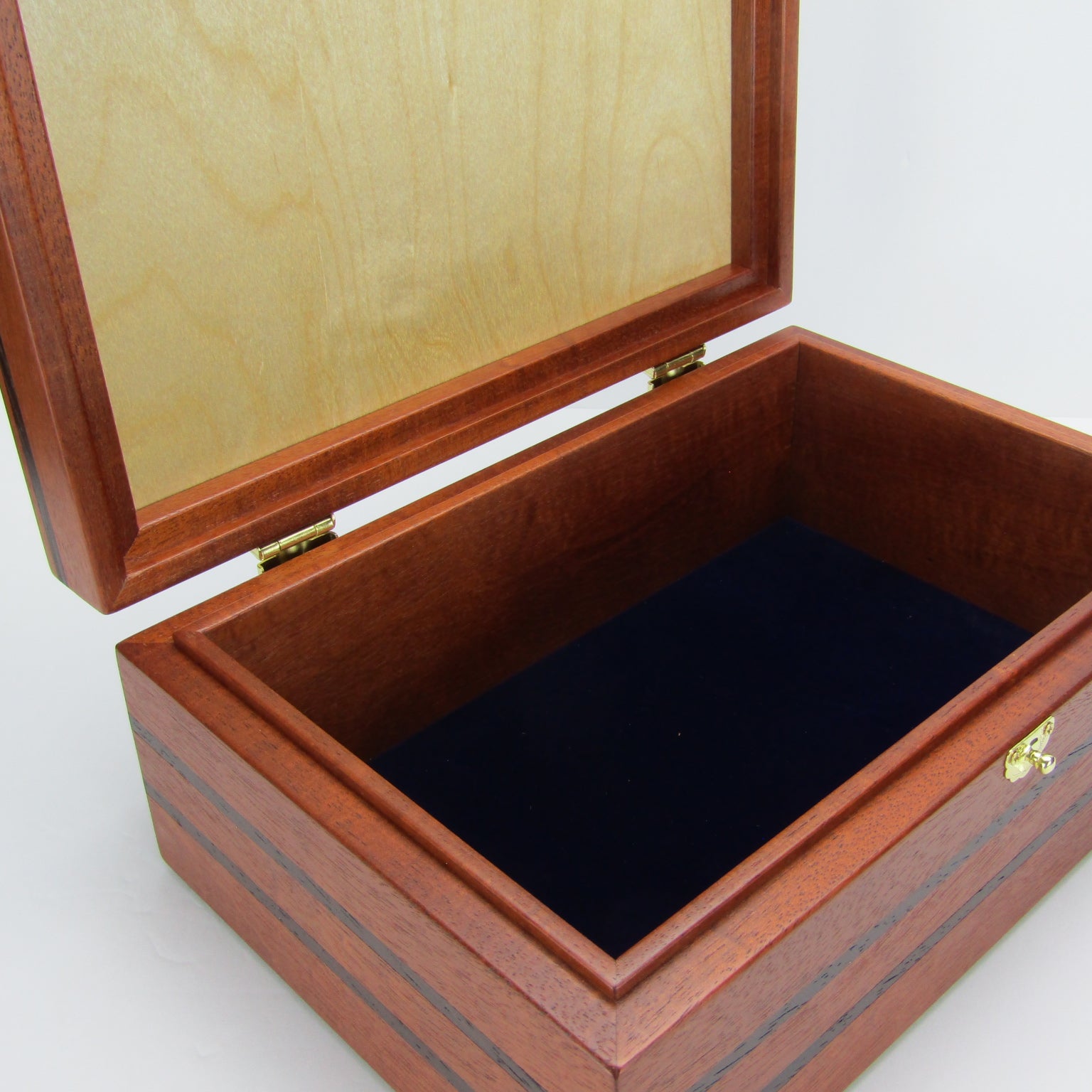 Interior view of valet box for men handcrafted from mahogany, with wenge inlay and a dark finished cherry veneer lid  by A Finer Cut Woodworking.