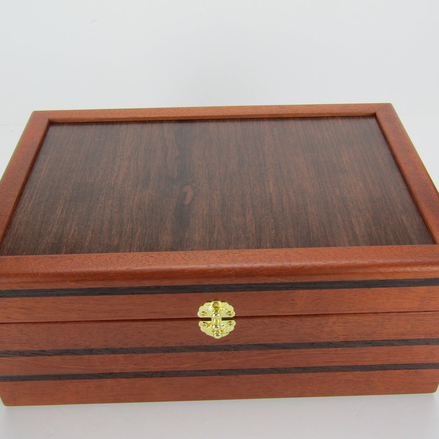 Top view of valet box for men handcrafted from mahogany, with wenge inlay and a dark finished cherry veneer lid  by A Finer Cut Woodworking.