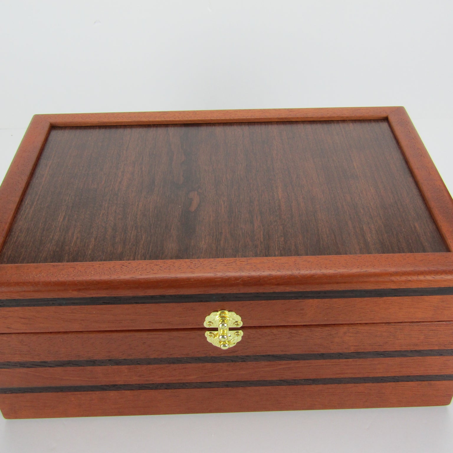 Top view of valet box for men handcrafted from mahogany, with wenge inlay and a dark finished cherry veneer lid  by A Finer Cut Woodworking.