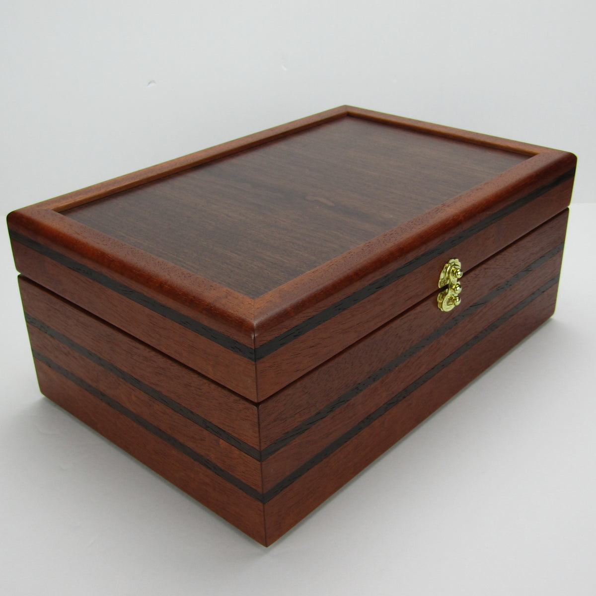 Front corner view of valet box for men handcrafted from mahogany, with wenge inlay and a dark finished cherry veneer lid  by A Finer Cut Woodworking.